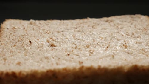 Full grain bread for toasting close-up surface 4K 2160p 30fps UltraHD tilting footage - Toast bread