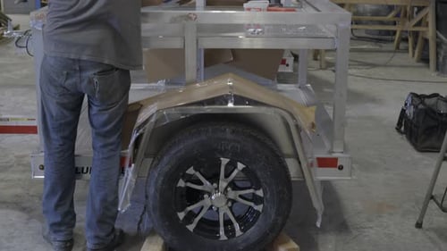 Worker drilling a hole into metal sheet
