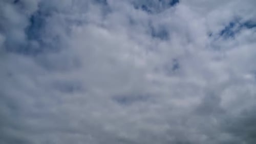 Clouds Drifting Slowly Across a Bright Blue Sky