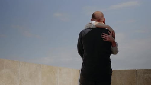 Joven pareja besándose en la cima de la torre del horizonte sobre la ciudad