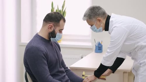 Doctor Taps Patient's Wrist With Reflex Hammer