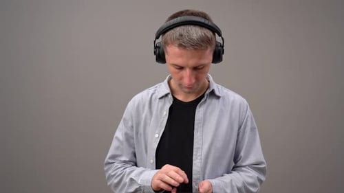 Young Adult Using Smartphone with Headphones