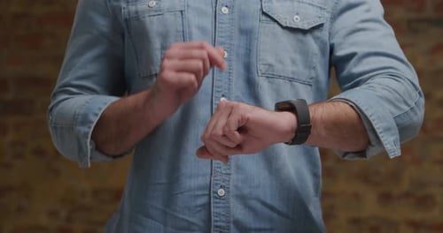 Man Using Smartwatch Device with Touchscreen