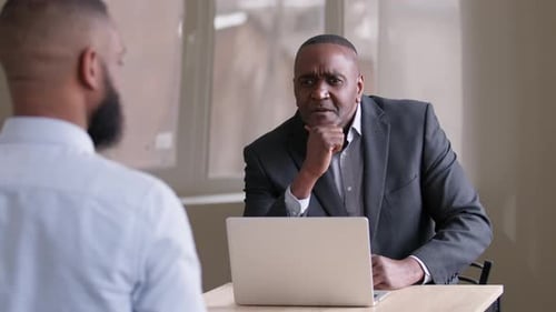 Two Men Meeting at a Workplace Office