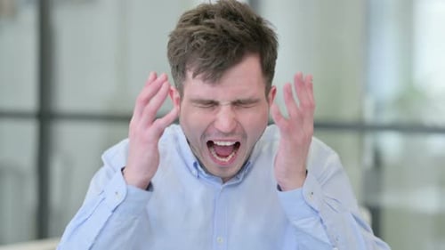 Frustrated Young Adult Man Yelling in an Office