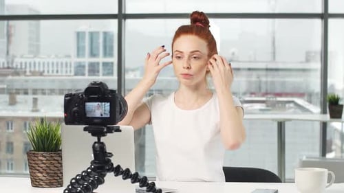 Red-Haired Woman Vlogging in Urban Office Setting