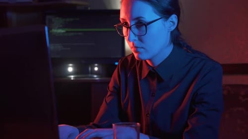 Girl Hacker in Glasses at the Computer Types Concept Idea