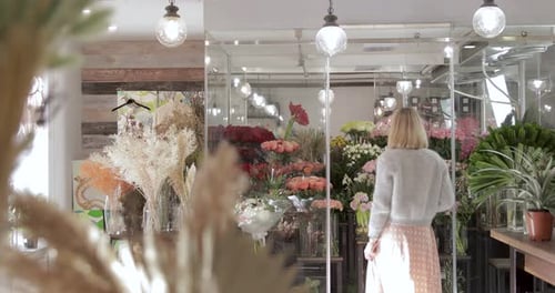 Woman Browsing Fresh Flowers in a Boutique