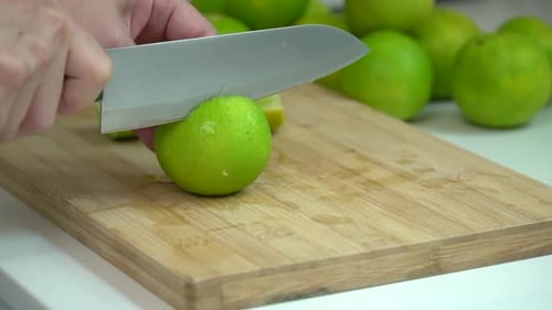Lime Being Cut on Wooden Cutting Board