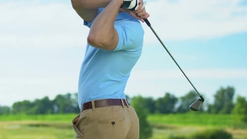 Back View Golfer Making Driver Shot From Tee Box, Using Professional Equipment