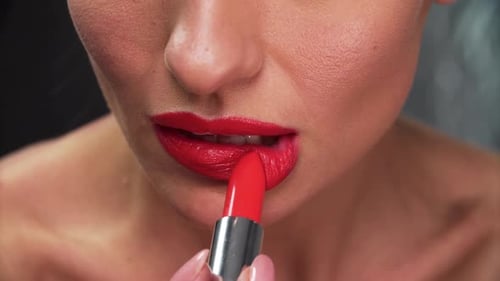 Applying Bright Red Lipstick Close-Up Beauty Shot