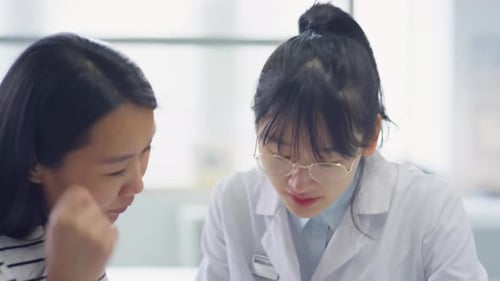 Doctor Consults Patient Using Tablet in Office
