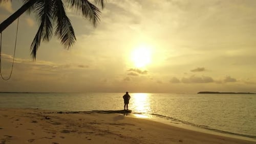 Girl tans on luxury seashore beach lifestyle by aqua blue ocean and white sand background of the Mal
