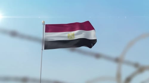 Waving Egyptian Flag Behind Barbed Wire Fence