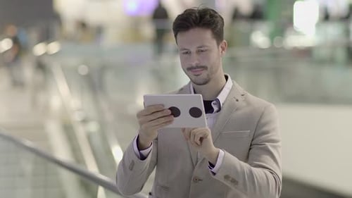 Man Using Tablet in Modern Urban Setting