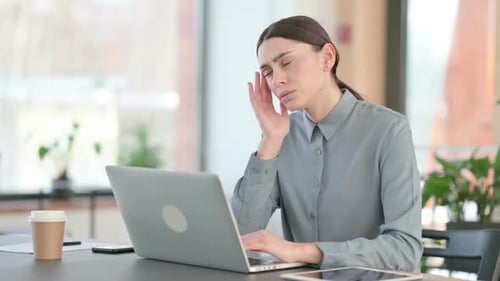 Woman Working at Laptop with a Headache