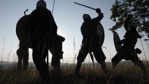 Silhouetted Warriors Engaging in Historic Battle