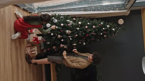 Mom and Daughter Decorating Christmas Tree
