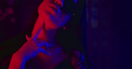 Close-up As a Girl Is Sexually Running a Finger Along the Neck. Fashion Looks in a Glasses. Shooting