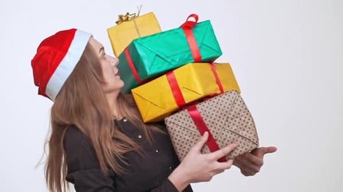 Woman with Gifts Wearing Christmas Hat