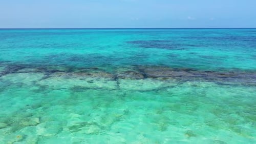 Aerial drone view tourism of idyllic resort beach lifestyle by blue ocean with white sand background