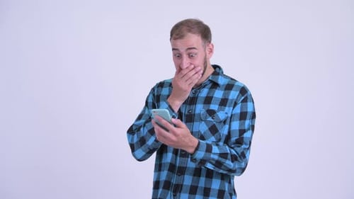 Man Looks at Phone, Gasps, Smiles, is Surprised