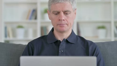 Adult Man Working on Laptop at Home