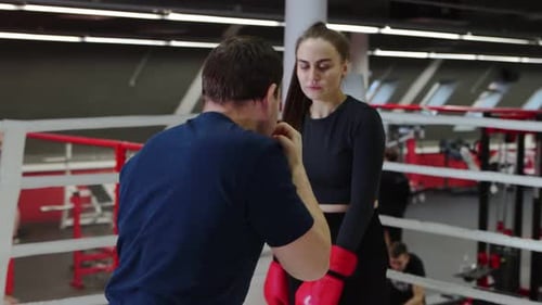 Woman Receives Boxing Instruction in a Professional Gym