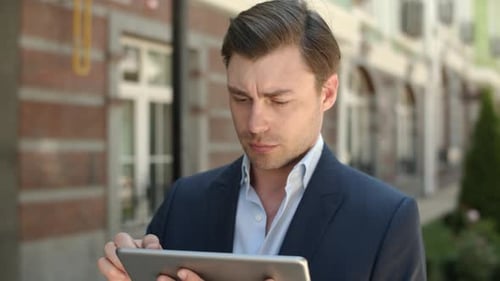 Closeup Man Holding Modern Touchpad at Street. Man Browsing Internet on Tablet