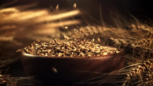 Grains Falling into a Wooden Bowl with Wheat