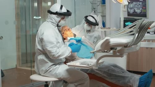 Dental Workers Perform Examination on Senior Woman
