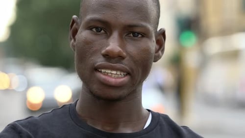 Young Man Smiling in Urban Setting