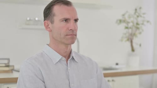 Man Portrait Indoors in Button-Up Shirt