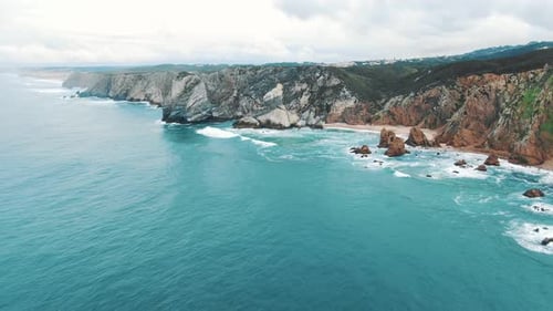 Azure Ocean Waves Roll on Empty Sea Coast with Cliff Rocks, Cabo Da Roca (Portugal)