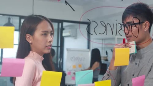 Young Adults Collaborate on Business Strategy in Office