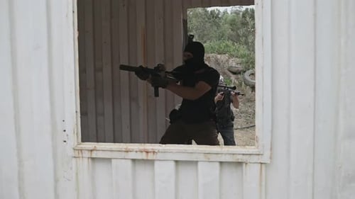 Men in Balaclavas Training in Urban Warfare Setting