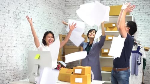Cheerful Colleagues Throwing Documents Up in Air