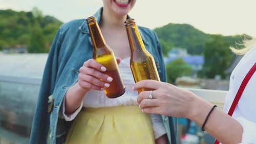 Young Women Drinking Beer Outdoors, Having Fun Outdoors.