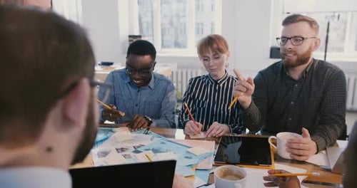 Creative Team Collaborating Around Table in Office