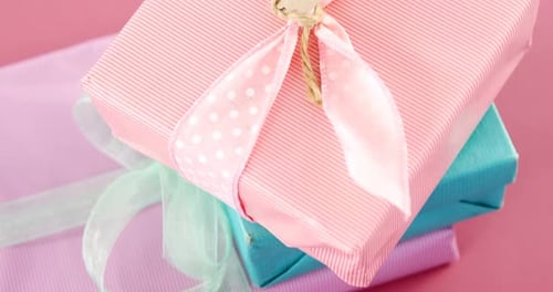 Stack of Wrapped Gifts with Mother's Day Tag