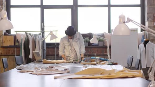 Male Fashion Designer Drawing Sketch in Sewing Studio