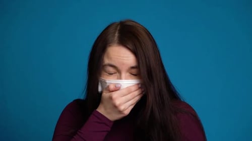 Woman Feeling Sick and Wearing Mask
