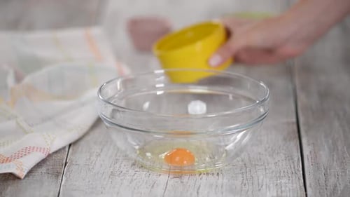 Whisking Egg and Sugar in a Glass Bowl.