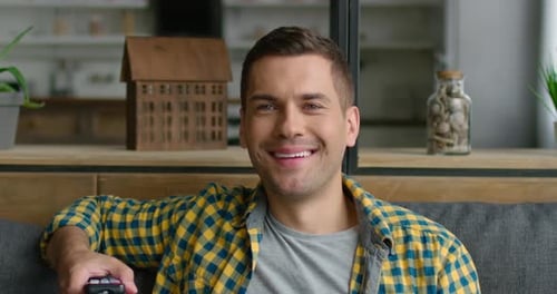 Young Man Enjoys Watching TV, Laughing at Funny Program, Film, Close Up