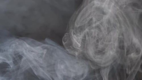 Swirling Gray Smoke Plumes on Dark Background