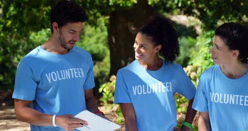 Volunteers discussing with each other in park 4k