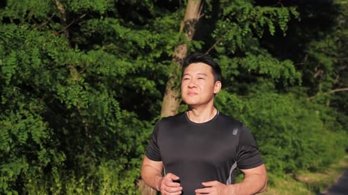 Man Runs Through Park on Sunny Day