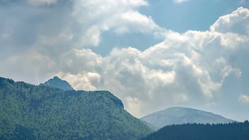 Dramatic Stormy Clouds over Green Forest Mountains Landscape in Spring Nature