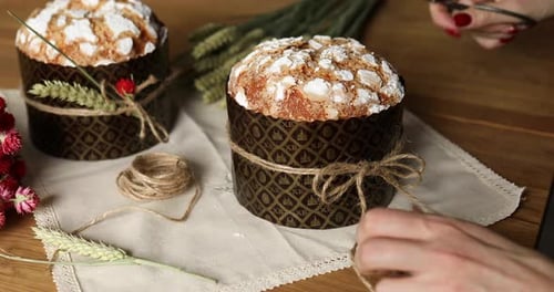 Hands Decorating Easter Cakes With String