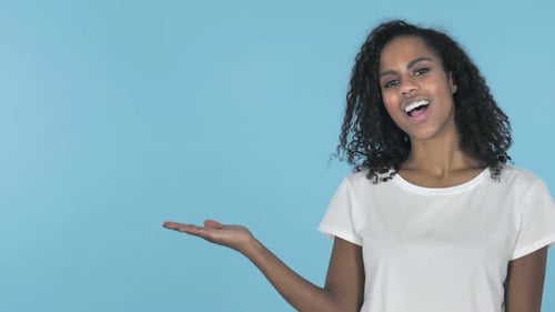 Young Woman Presenting to Her Side